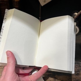 Blank notebook. Leather-bound back. ("Merci Louis")