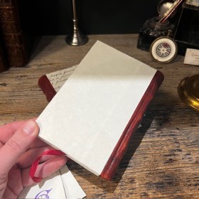 Blank notebook. Leather-bound back. ("Merci Louis")