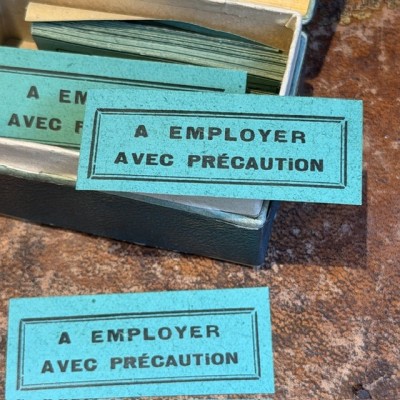 To be used with care - Antique labels in a pharmacy box for remedy in canvas cardboard
