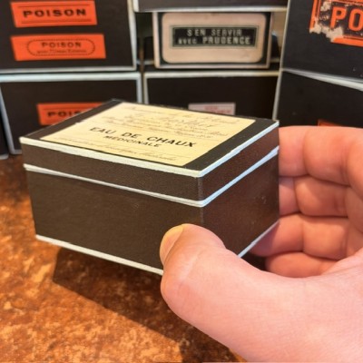 Eau de Chaux Médicinale - Antique labels in a pharmacy box for remedy in canvas cardboard